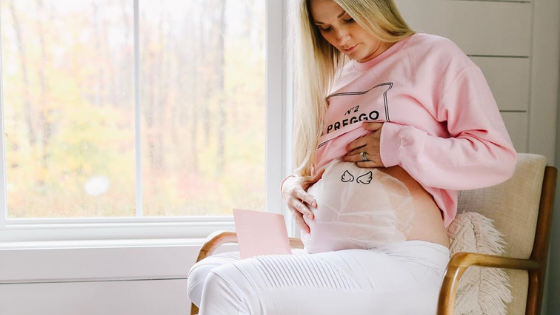 [#BumpStyleApproved: Mama Cassie Shows Off Her White Maternity Leggings] - {Cassie wearing White Out Moto Leggings and Pink Maternity Sweatshirt]